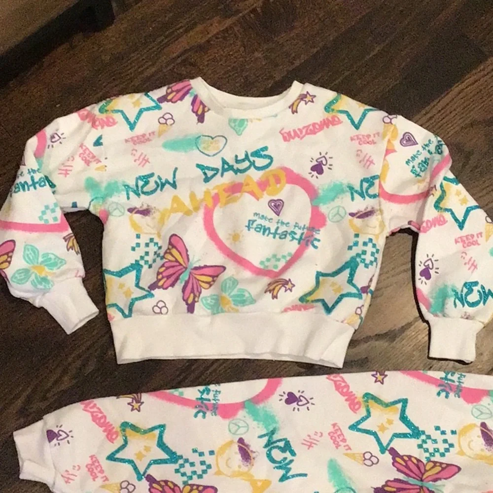 PRIMARK -children's tracksuit featuring a colorful all-over graffiti-style print